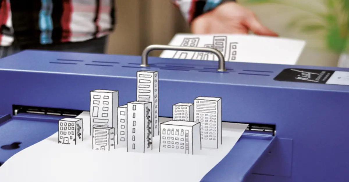 Máquina de relevos PIAF a imprimir uma imagem tátil de edifícios